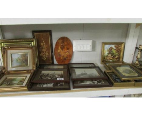 A shelf of framed and glazed prints