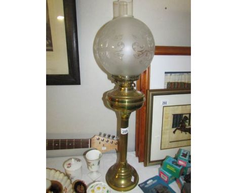 An oil lamp with etched shade