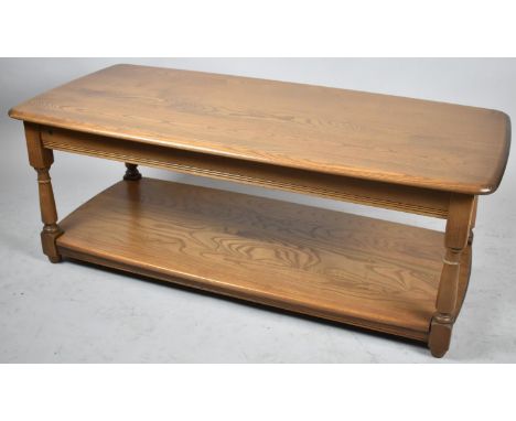 A Modern Ercol Rectangular Coffee Table with Stretcher Shelf and Turned Supports, 115cms Wide 