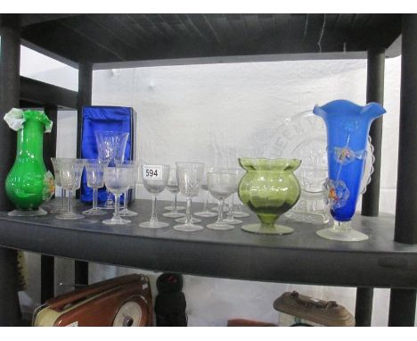 A shelf of glassware including early glasses