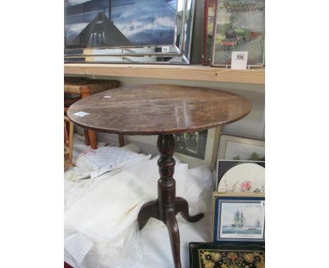 A wooden tripod table