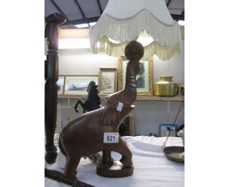 A lamp with wooden elephant as base