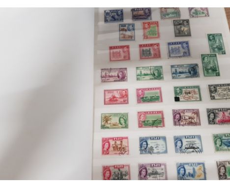 STAMP ALBUM CONTAINING A LARGE QUANTITY OF LOOSE COMMONWEALTH STAMPS NIGERIA, CEYLON AND FIJI ETC