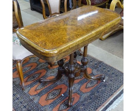 A 19th century burr-walnut foldover card table, raised on a quadruple column support and sabre leg, W95cm, H73cm 