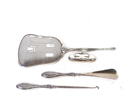 A silver-handled button hook and a matching shoe horn, a silver-mounted nail buffer, and an Art Deco style silver plated hand