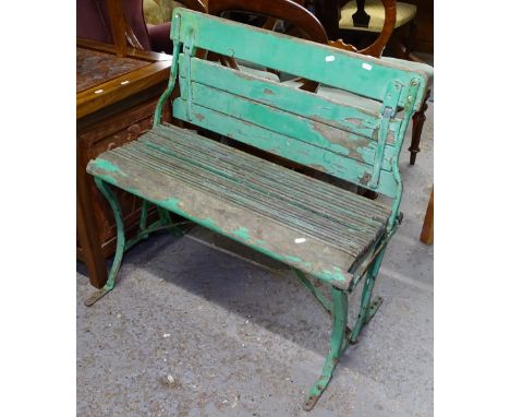 A Vintage green painted railway station platform bench, with sliding back, W86cm 