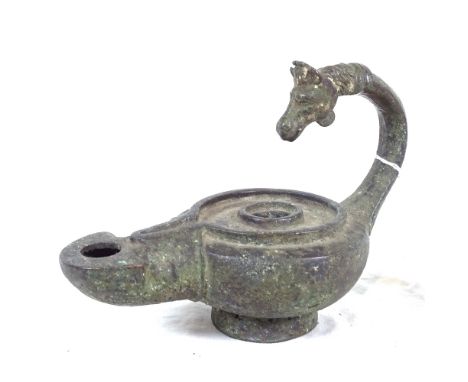 A cast-iron verdigris oil lamp, with horse-head handle, length 18cm 