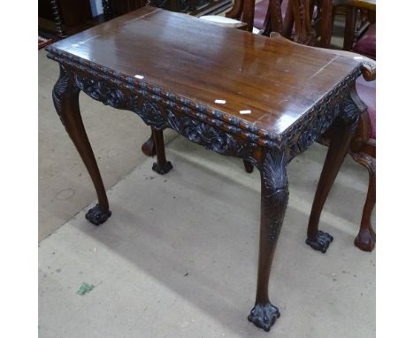 A mahogany rectangular foldover card table, with carved edge and frieze, raised on cabriole legs with claw and ball feet, W84