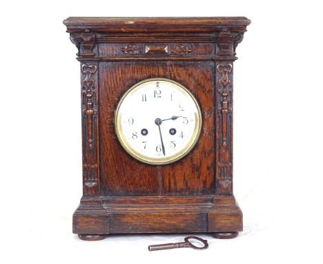 A French Maple &amp; Co oak-cased mantel clock, white enamel dial with carved case, height 30cm 