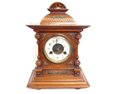 A carved oak-cased 2-train clock, height 35cm, and a mahogany bracket 