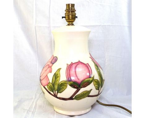 A Moorcroft cream ground table lamp with tube-lined peony decoration, height 32cm overall 