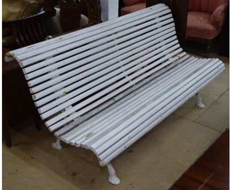 A 19th century slatted garden bench, of shaped form, on cast-iron legs, L167cm, H77cm 