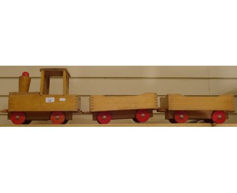 A child's wooden carpet train and 2 trailers, main engine length 37cm 