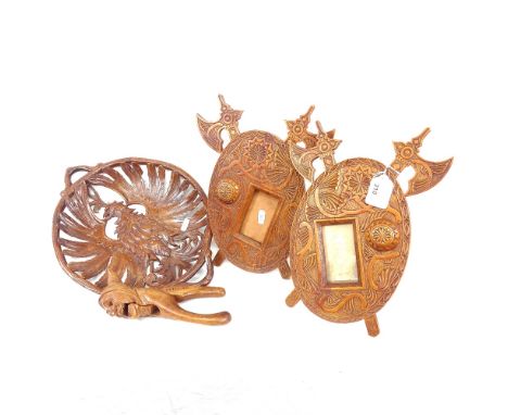 Black Forest carved wood nutcracker of a troll, signed Chillon, 2 carved wood photo frames, and a Black Forest eagle platter,