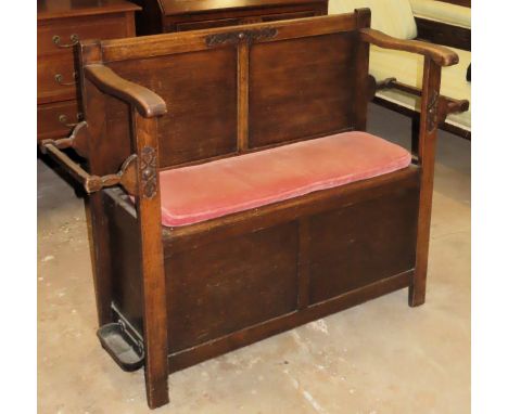 Early 20th century carved oak narrow monks bench with lift up seat and stick stands to either side. Approx.  87 x 115 x 41cms