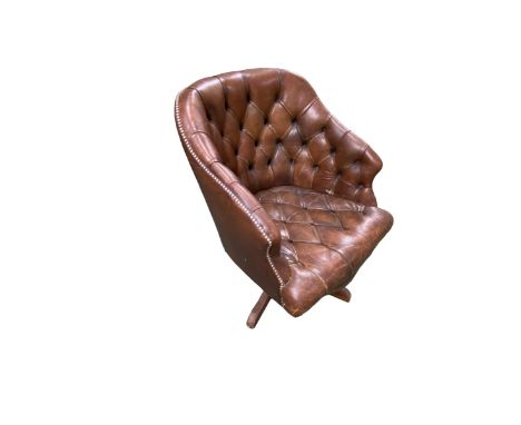 A good Hillcrest swivel tub arm chair in studded button back leather, with serpentine apron on a quadruped base, some wear, 5
