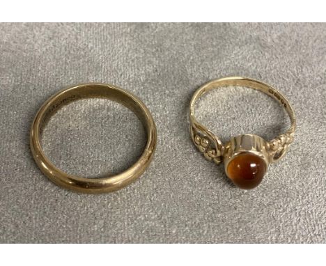 A 9ct gold orange garnet (spessartite) set dress ring together with a 9ct gold band. 5.73g. Size O/N 