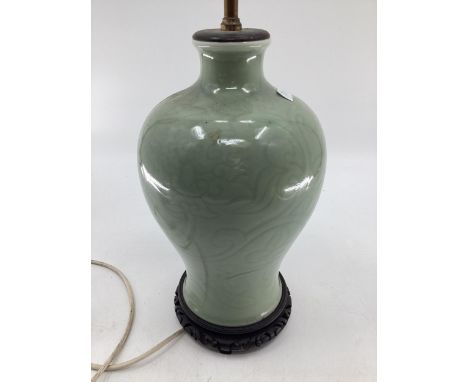 Chinese style green ceramic lamp base, with brass fittings for bulbs, on hardwood stand 