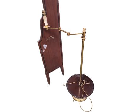 A brass standard lamp, with hinged arm and circular mahogany book rest 