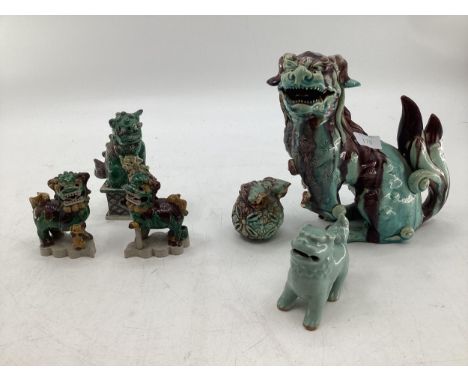 Six decorative ceramic figurines of Dogs of Fo, in a green and blue glaze, highest measuring 23cmH 