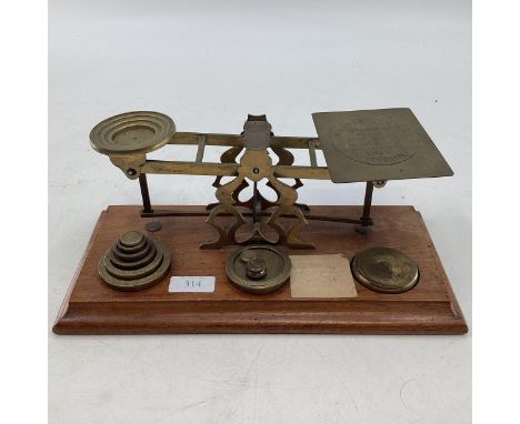 A set of early 20th century postal scales with related weights. 