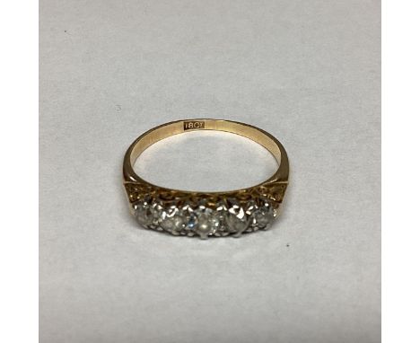 A 18ct gold and diamond ring. Five graduated old cut diamonds. 2.86g. Size N 