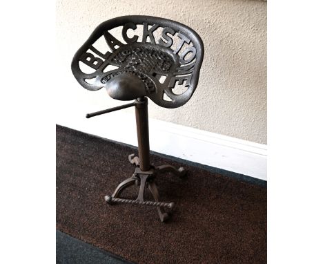 Caste iron Blackstone &amp; Company Ltd, Stamford tractor seat stool, with extending height base on caste feet&nbsp;