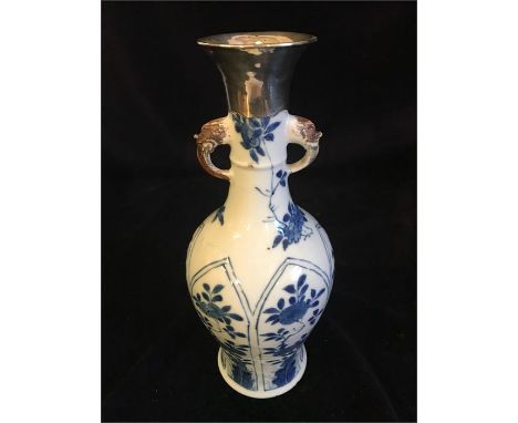 A Kangxi period Chinese blue and white vase with silver top.