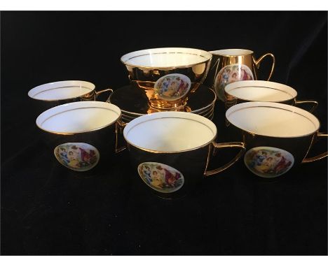 A set of five Czechoslovakian gold tea cups and saucers, milk jug and sugar bowl