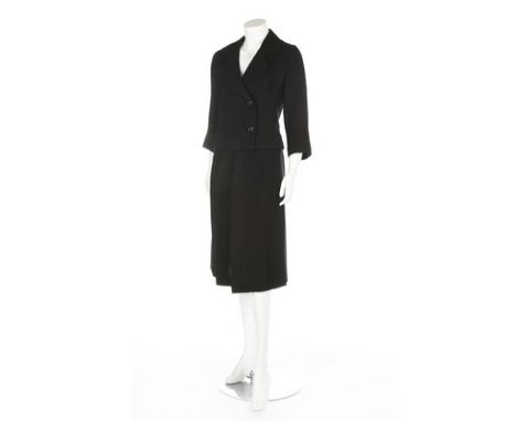 A Balenciaga couture black boucle wool suit, Autumn/Winter 1960, Paris labelled and numbered 78720 to jacket only, with curve