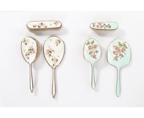 Assorted guilloché enamel vanity accessories, 1920s-50s, comprising; silver mounted mirror and two brushes, painted with pink