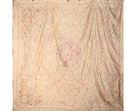 An embroidered ivory satin coverlet, Canton, Chinese, circa 1920, the central medallion with a mandarin and his lady taking t