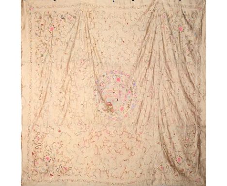 An embroidered ivory satin coverlet, Canton, Chinese, circa 1920, the central medallion with a mandarin and his lady taking t