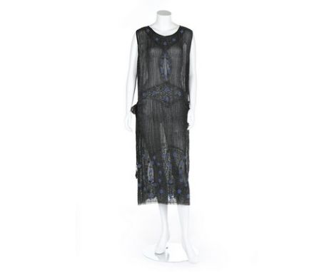 A beaded black chiffon tabard dress, circa 1924-5, covered with a shimmer of black bugle beads with blue beaded flowerheads, 