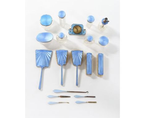 A large group of blue quilloché enamel vanity accessories, 1920s-30s, comprising: five-piece silver mounted set, 1935; six si