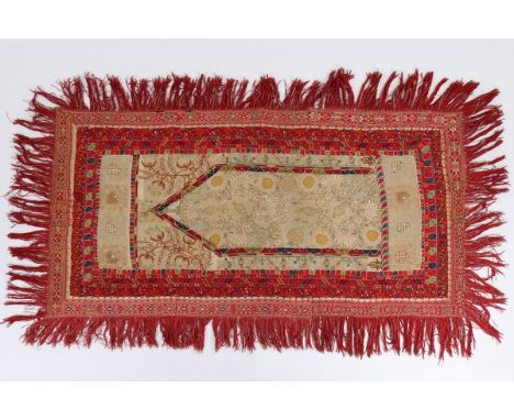 A composite Qibleh cloth, Ottoman, assembled circa 1870, the fabrics from the 18th and 19th centuries, the central mihrab of 