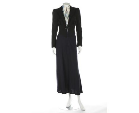 An Ossie Clark cropped black wool gabardine jacket, circa 1970, printed label and size 10, with pointed front waist, linked b