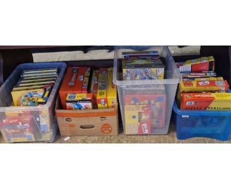 Four boxes of The Simpsons jigsaws and board games to include: Monopoly, circular jigsaws, Battle of the Sexes, Don't Panic e
