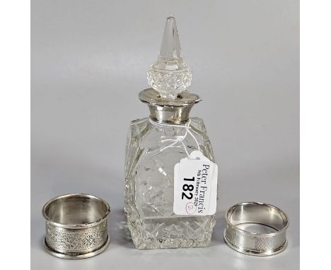Two silver engraved and engine turned napkin rings. 0.9 troy oz approx. Together with a silver collared scent bottle and stop