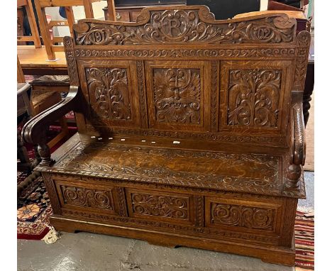 Edward VII ornately carved oak settle, the carved back dated 1902 with the letter R above three panels, one with carved Green
