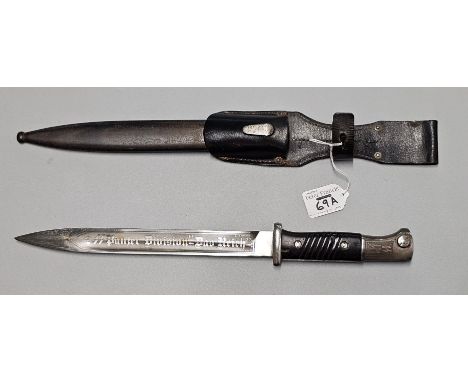 German WWII period K98 bayonet, blade marked WKC and having eagles head pommel with black wooden grip and leather frog, steel