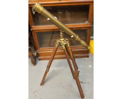 Reproduction brass telescope on tripod folding stand. (B.P. 21% + VAT).&nbsp;A decorative item only - not a serious optical i