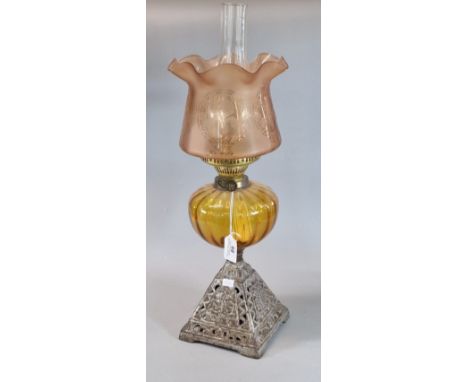 Early 20th century double oil burner lamp, having orange clear and frosted foliate shade above an orange fluted reservoir on 