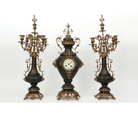 antique brass garniture with a pair of candelabra and a clock with a "F. Marti - Medaille d'Argent 1889" signed work || Antie