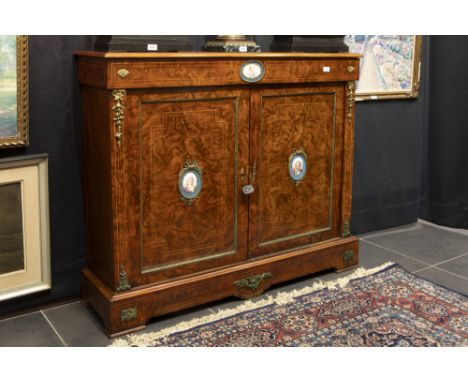 mid 19th Cent. European neoclassical cabinet in burr of walnut with mountings in guilded bronze and with plaques in Sèvres-po