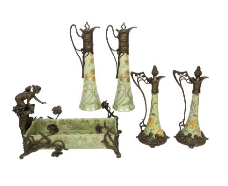 five pieces of Art Nouveau style ceramic with bronze mountings and whiplash ornamentation : four decanters and a planter || L