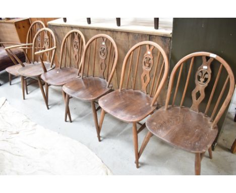 A set of six (four plus two) Ercol chairs having fleur de lys style hoop and stick back, and a similar easy chair