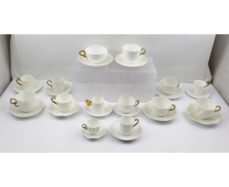 A COLLECTION OF FOURTEEN ASSORTED WHITE CERAMIC TEA AND COFFEE CUPS WITH SAUCERS, all the cups have gilded handles, factories
