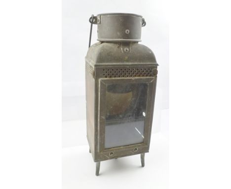 A LATE 19TH CENTURY LANTERN with swing handle, raised on four feet, 34cm high 