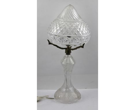A CUT GLASS TABLE LAMP with cut glass conical shade, the shade raised upon three gilt metal arms. 54cm high. 
